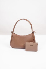 Women's brown handbag and wallet isolated on white background