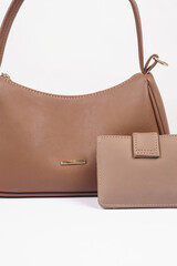 Women's brown handbag and wallet isolated on white background