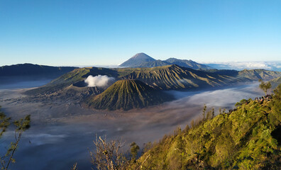 Mount Bromo at morning light, Volcanic mountains with misty valley at sunrise, Gems of East Java