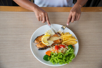 Top view Businessman hands eat Ribs eye Steak have lunch at restaurant. Men hands steak cutting meat enjoy eating with mashed potato, salad cream French fries Barbecue Grill Meat beef beefsteak