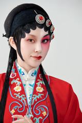 Female actress in red performing Chinese opera movements