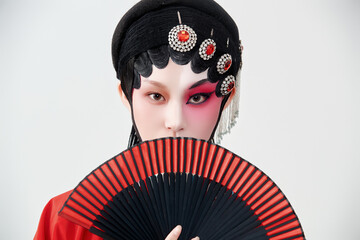 Female actress in red performing Chinese opera movements