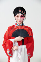 Female actress in red performing Chinese opera movements