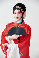 Female actress in red performing Chinese opera movements