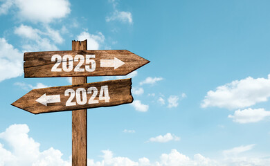 Wooden sign saying goodbye to the old year 2024 with welcome the new year 2025. New year symbol and...