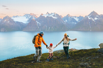 Family travel holidays in Norway - Mother, father, and child hiking together in mountains, parents and kid having fun on active outdoor vacations. People enjoying landscape, healthy lifestyle trip