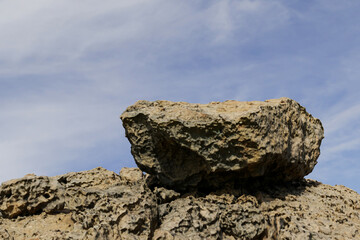 3d render summer platform and natural stage background, A large rock is on a rocky hill Backdrop sky and cloud for product display, advertising, mockup or etc