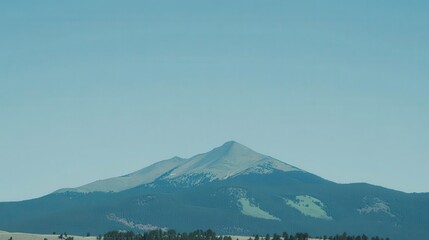 Majestic mountain under clear blue sky.