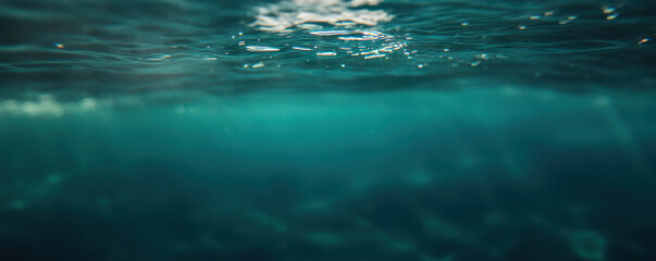 Calm ocean surface with shimmering light reflections, serene underwater view, peaceful marine backdrop.