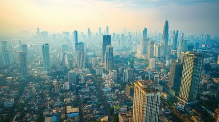 Fototapeta premium Aerial view of Bangkok dense cityscape, with high-rise buildings and winding streets