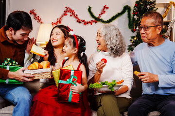 Parents, children, and grandparents gather at home for a joyful Christmas and New Year celebration, also marking the granddaughter’s birthday. They share wine, food, drinks, and exchange gift boxes