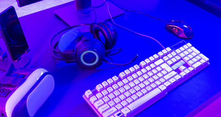 Close up gamer work space gaming set up modern equipment on desk, gaming gear, mouse, headset, computer mouse ready for online streaming © sorapop