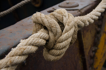 Fototapeta premium A rope is tied frayed and worn.