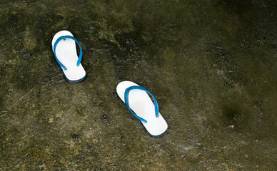 White sandals with blue straps on the soles.  with free space.