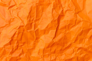 Top view and full frame of wrinkled or crumpled orange paper used as crumpled orange paper background texture