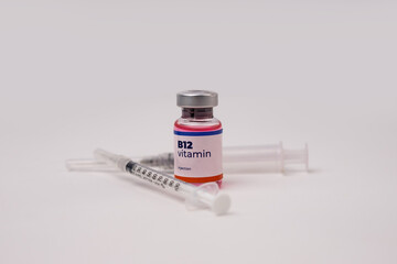 a liquid vitamin b12 with 2 syringes on the clinic table. health and medical concepts