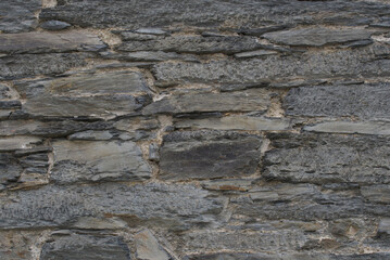Obraz premium Old house wall with textured stone cut, close-up