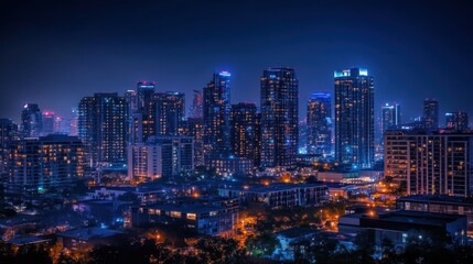 Obraz premium A stunning view of a city skyline illuminated by vibrant lights, showcasing the beauty of urban life after dark, encapsulating the energy and charm of nighttime cityscapes.