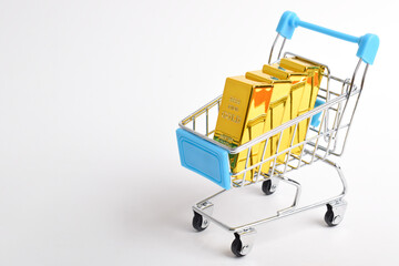 Gold bars in shopping cart. Financial concept, trading, high demand purchases