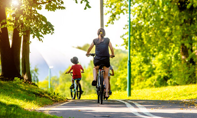 Fototapeta premium Cyclists ride on the bike path in the city Park 
