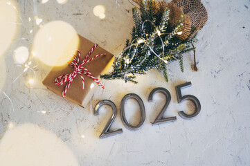 New Year's lights gold and dark red colors bokeh background with glowing number 2025 and fireworks. Happy New Year concept for 2025.