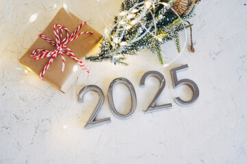 New Year's lights gold and dark red colors bokeh background with glowing number 2025 and fireworks. Happy New Year concept for 2025.