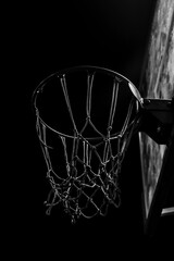 basketball hoop. night scene. streetball. silhouetted basketball goal at evening. basketball net at night. photo of basketball net. isolated on black background. Playground. outdoor scene.