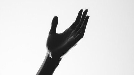Fototapeta premium Silhouette of an open hand against a bright white backdrop, emphasizing a minimalist style and graceful lines.