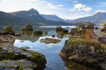 Fototapeta premium Colorful Autumn scenery and reflections on the lake Altausseer See, Bad Aussee, Salzkammergut, Styria, Austria, Europe, with the mountains and the Dachstein in the background