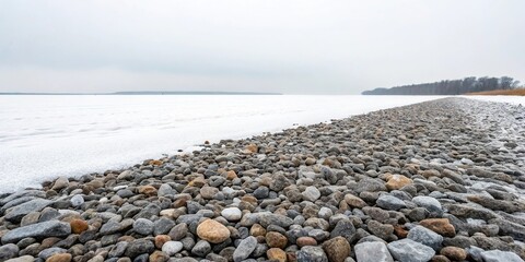 A vast expanse of crushed stone and gravel on a snowy white backdrop, frosty landscape, desolate scenery, crushed stone, frozen ground