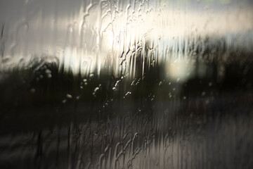 Wet glass. Jets of rain on the glass. Spray on the window. Rain on the street.