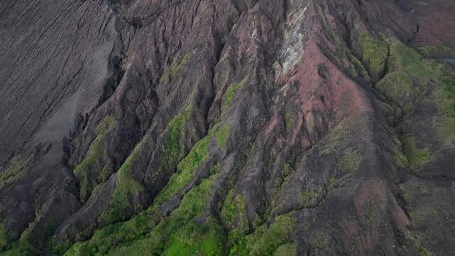 Drone rising over Mount Yasur to the crater rim. Active smoking volcano in Vanuatu, Pacific Islands.