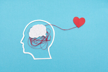 Creative Concept of Emotional and Mental Health with Brain Puzzle Connected to a Heart on Blue...