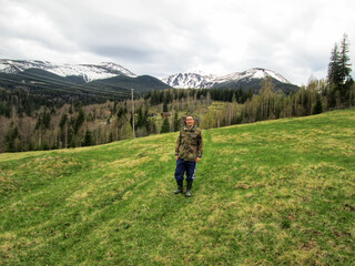 One tourist travels to the snowy mountains in early spring