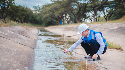 Expert biologists are checking the cleanliness of industrial water and collecting samples to test...