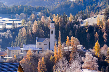 Scenic aerial view of alpine landscape with idyllic Swiss mountain village of Tiefencastel at Albula Valley on a sunny autumn day. Photo taken November 15th, 2024, Tiefencastel, Switzerland.