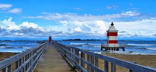 Panorama of the two lighthouses in Lignano Sabbiadoro in cloudy, rainy weather.