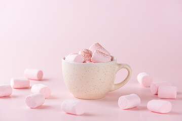 Vegan chocolate drink with marshmallows in a mug on a pink background. Homemade, sugar and lactose free.