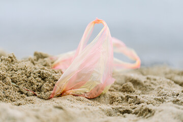 Plastic bag left on sandy beach