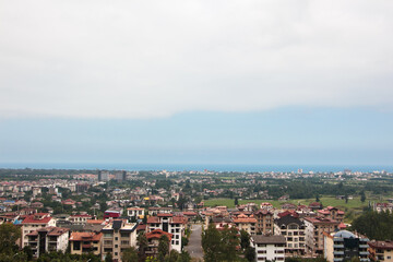 Obraz premium Aerial View of a Coastal City with Residential Buildings and Sea Horizon (The coastal city of Namak Abroud)