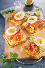bread toast with avocado, salmon and egg