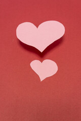two pink hearts on a red background valentine background . Valentine concept