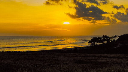 sunset over the sea, beautiful black sand Nyanyi Beach, West Bali.