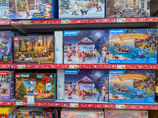 Obraz premium France, 06 November 2024 : Toy store shelf displaying LEGO and Playmobil advent calendars