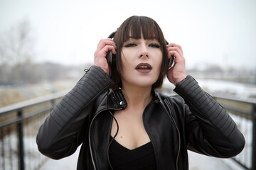 Fototapeta premium Girl in headphones listening to music outdoors
