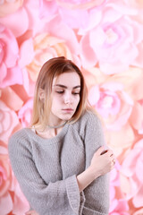 Girl with blond hair and gray sweater