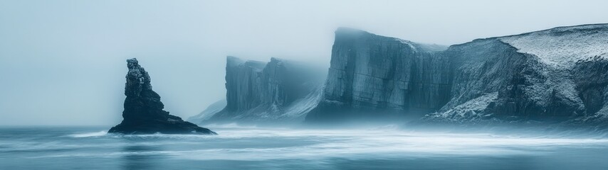 Misty coastline with dramatic cliffs and serene ocean waves, creating a tranquil and atmospheric landscape scene.