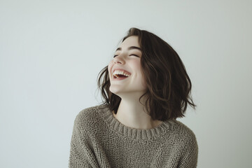 Fototapeta premium Laughing young woman, positive emotions, casual style, candid portrait, joyful expression, happiness and carefree mood, cheerful female, minimalist background