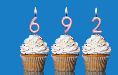 Birthday Cupcakes With Candles Lit Forming The Number 692