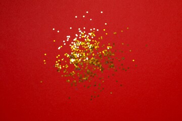Golden confetti on color background, top view
